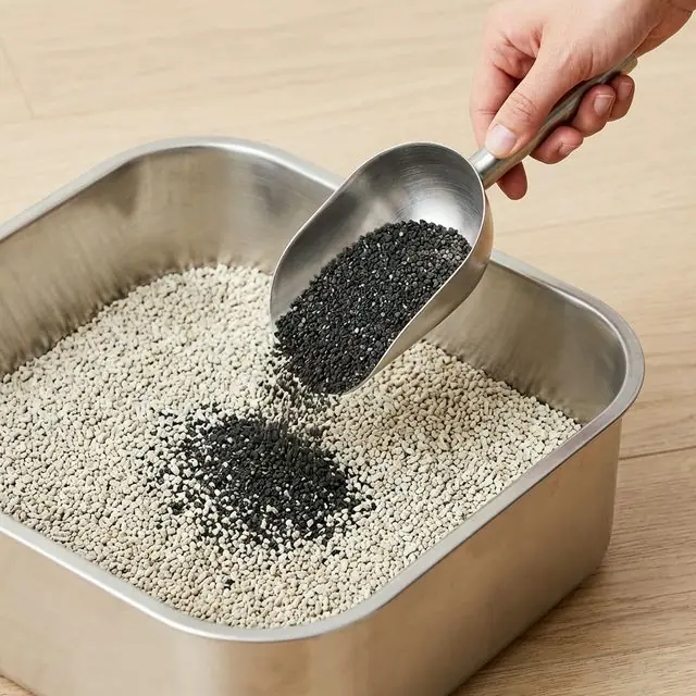Hands sprinkling Purrify granules onto litter
